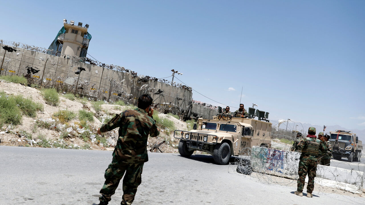 FILE PHOTO: Afghan soldiers stand guard at a checkpoint outside the U.S Bagram air base, on the day the last of American troops vacated it, Parwan province, Afghanistan July 2, 2021.REUTERS/Mohammad Ismail/File Photo