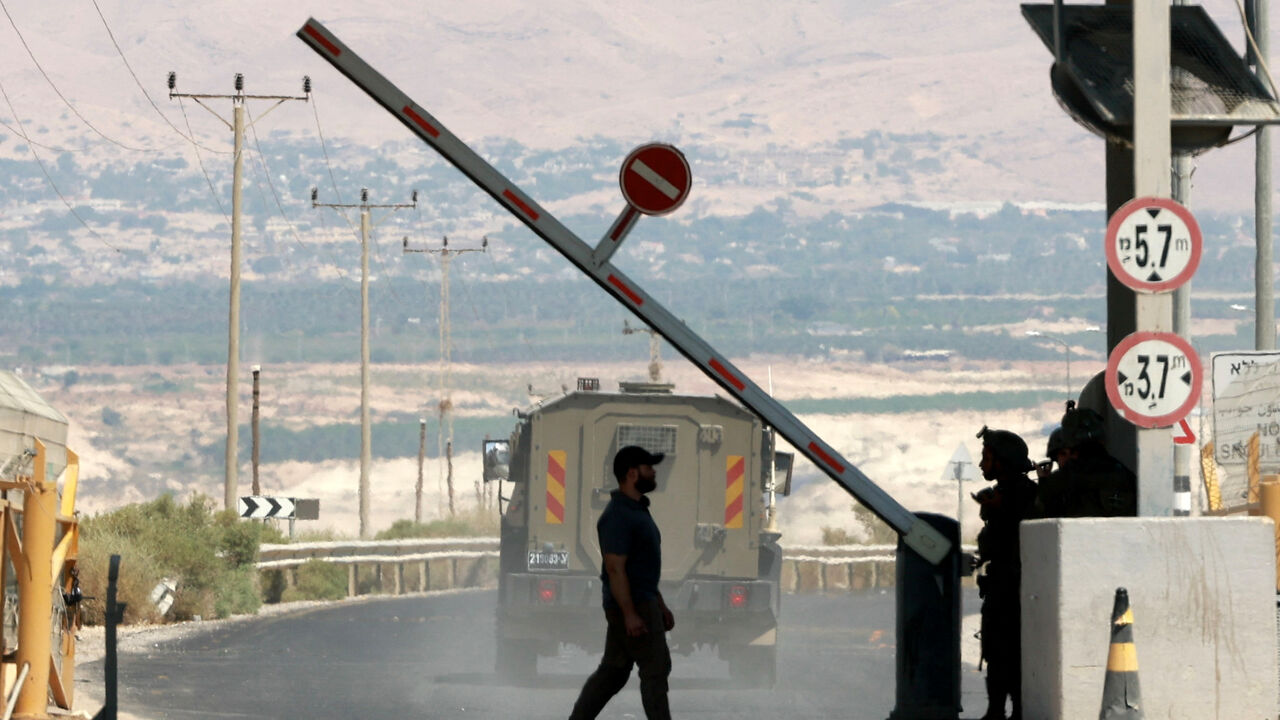 A man walks at a barrier, at the Allenby Bridge Crossing between the West Bank and Jordan, September 8, 2024. REUTERS/Ammar Awad/File Photo