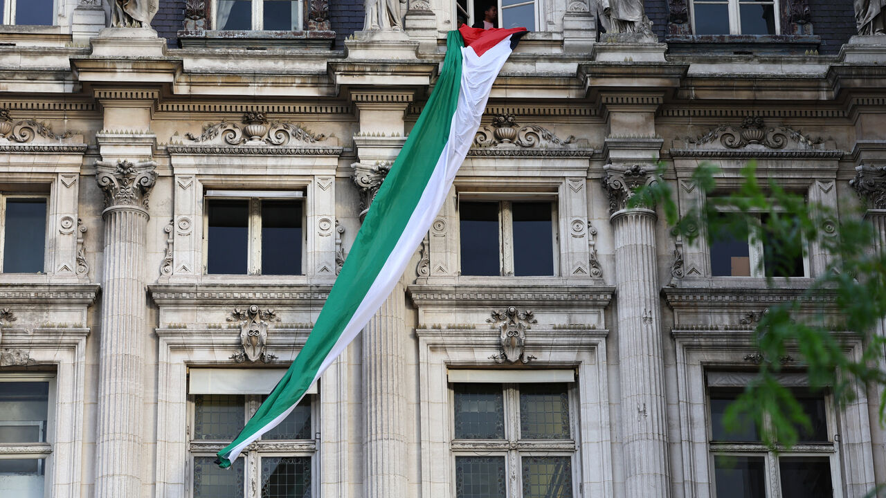 FILE PHOTO: A Palestinian flag, unfurled by activists, hangs over Paris City Hall in Paris, France, September 22, 2025. REUTERS/Abdul Saboor/File Photo