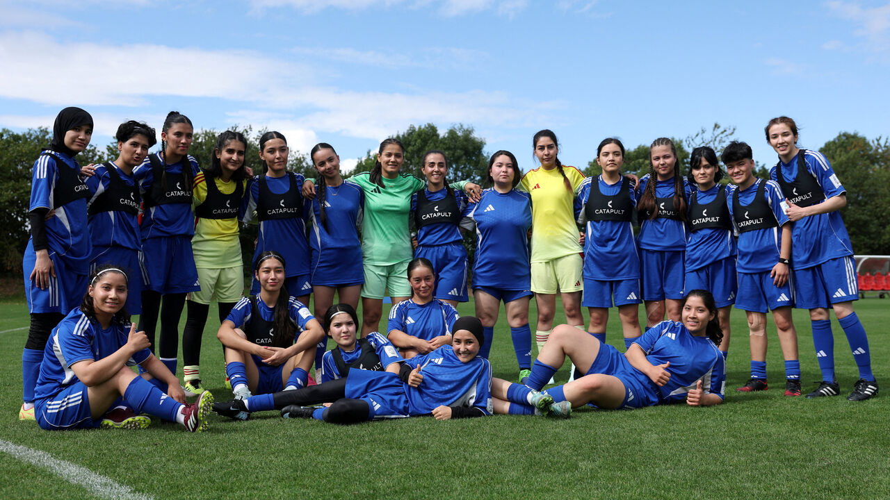 FILE PHOTO: Soccer Football - Members of the Afghan Women's Refugee team pose for a team group during a selection camp at St. George's Park, Burton upon Trent, Britain - August 26, 2025 REUTERS/John Sibley/File Photo
