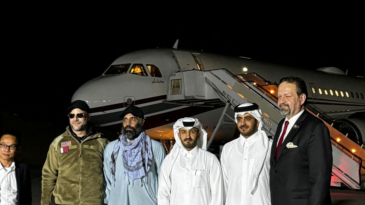 Amir Amiri, who had been detained in Afghanistan since December 2024, poses for a picture alongside Adam Boehler, the U.S. special envoy for hostage response, Sebastian Gorka, the deputy assistant to the U.S. president and senior director for counterterrorism, Qatari diplomats and others before boarding a plane in Kabul Afghanistan, September 28, 2025 in this handout image. Qatari Diplomat/Handout via REUTERS