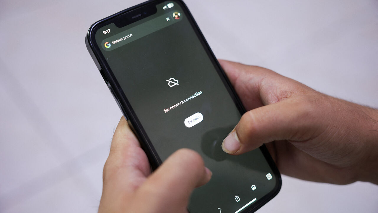 A man tries to use Google on his smartphone amid total telecom shutdown across the country, in Kabul, Afghanistan, September 30, 2025. REUTERS/Sayed Hassib