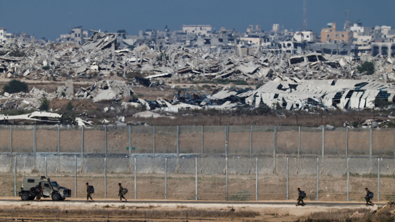Israeli soldiers walk on the on Israeli side of the Israel-Gaza border, September 30, 2025. REUTERS/Amir Cohen