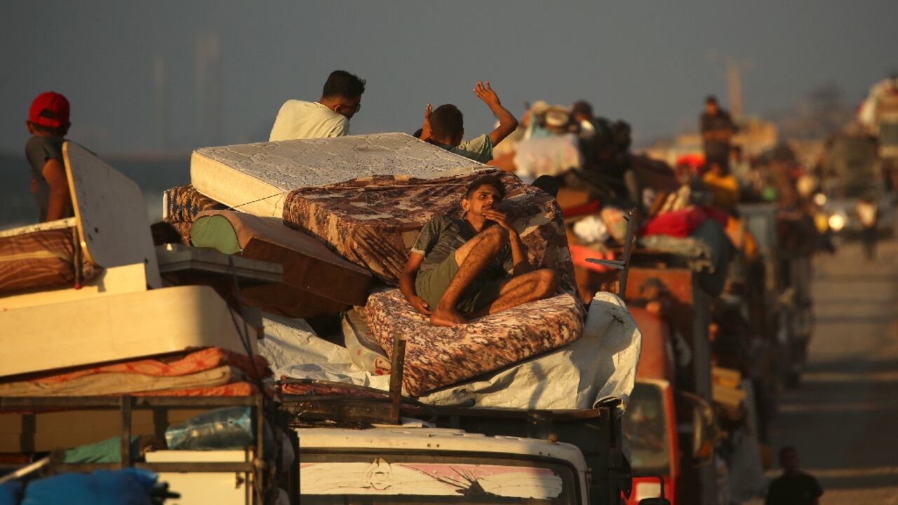 Displaced Palestinians move southwards on a road in the central Gaza Strip, as Israel presses its assault on Gaza City