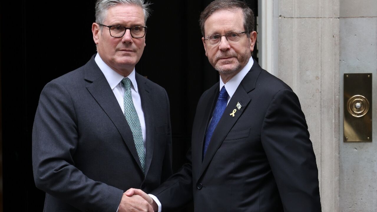 Britain's Prime Minister Keir Starmer (L) greets Israel's President Isaac Herzog on the steps of 10 Downing Street