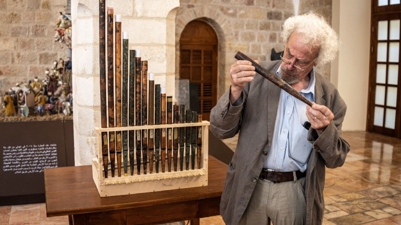 A man inspects a piece of the functioning replica from the oldest organ in Christendom, during the instrument's unveiling at the Saint Saviour's Monastery in the old city of Jerusalem