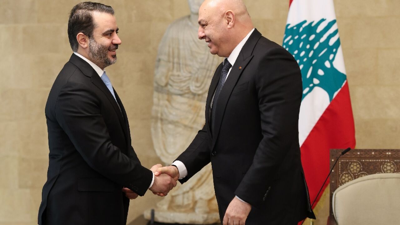 Lebanon's President Joseph Aoun greets Syria's Foreign Minister Asad al-Shaibani before a meeting at the presidential palace in Baabda, east of Beirut