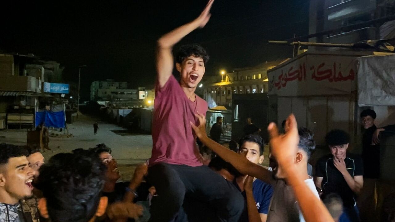 Men celebrated in southern Gaza's Khan Yunis after the deal was announced