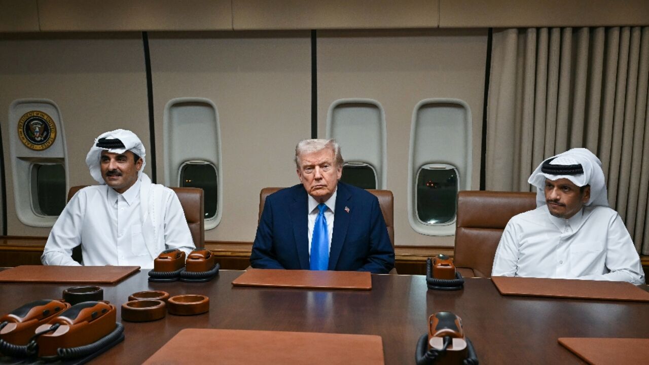 US President Donald Trump meets Qatar's Emir Sheikh Tamim bin Hamad Al-Thani (L) and Prime Minister Sheikh Mohammed bin Abdulrahman bin Jassim Al-Thani (R) aboard Air Force One