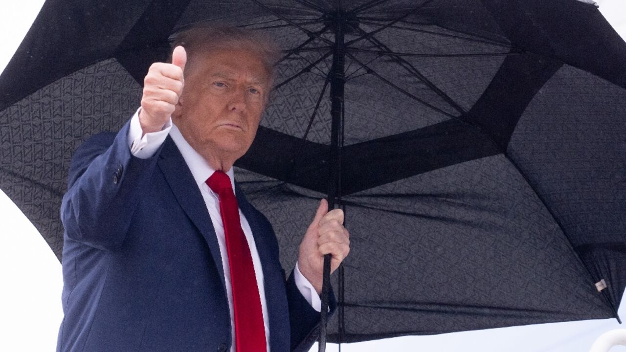 US President Donald Trump gives a thumbs up while boarding Air Force One bound for Israel, where he will address parliament and meet with hostage families, and then Egypt for a major peace summit