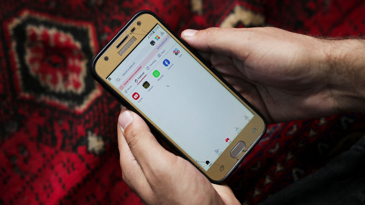 A man checks his smartphone to connect to the internet, amid telecom shutdown across the country, in Kabul, Afghanistan, September 30, 2025. REUTERS/Sayed Hassib