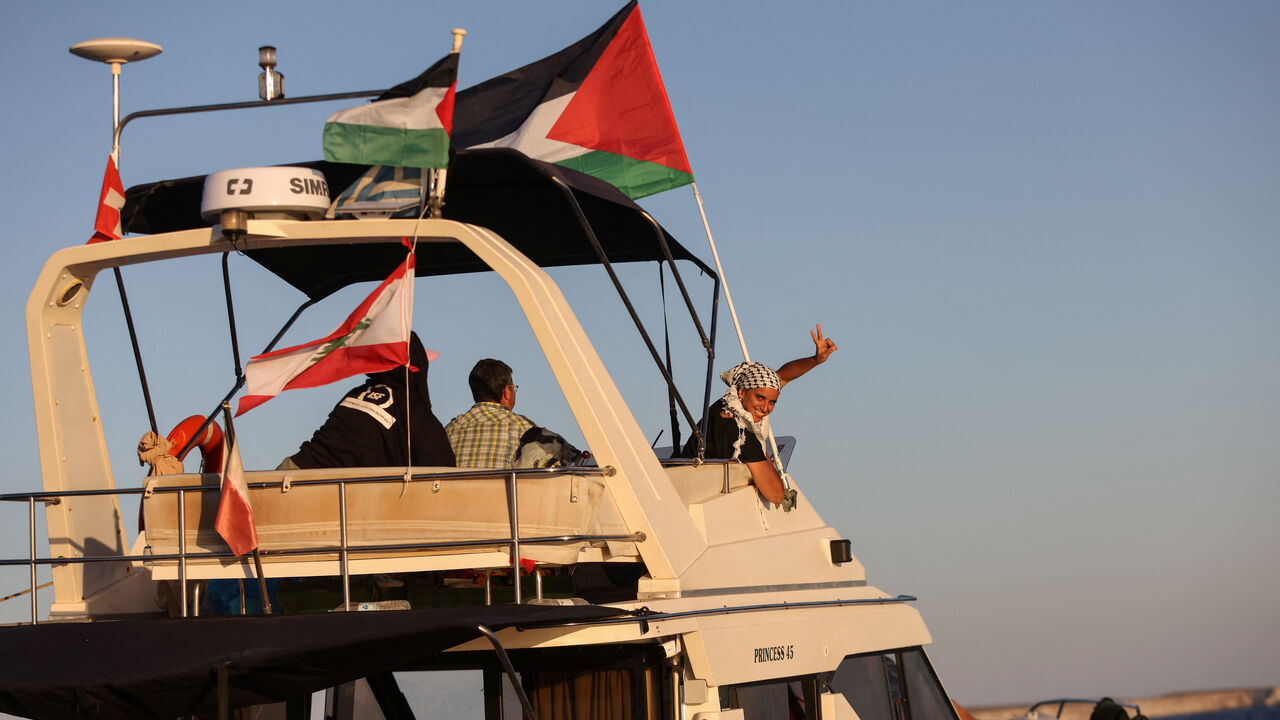 A woman gesture aboard a boat, part of the Global Sumud Flotilla aiming to reach Gaza and break Israel's naval blockade, as it sails off Crete island, Greece, September 25, 2025. REUTERS/Stefanos Rapanis