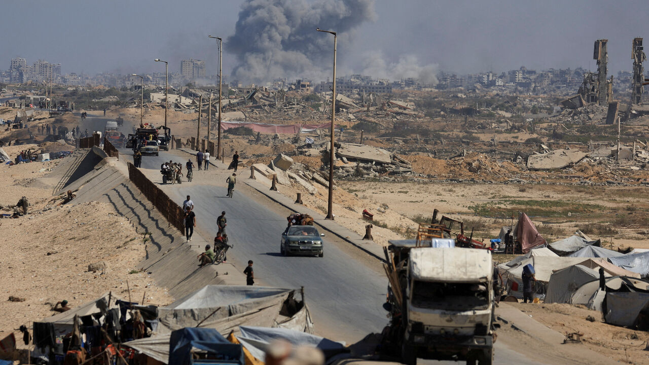 Smoke rises during an Israeli military operation as displaced Palestinians fleeing northern Gaza move southward after Israeli forces ordered residents of Gaza City to evacuate, in the central Gaza Strip, September 30, 2025. REUTERS/Dawoud Abu Alkas