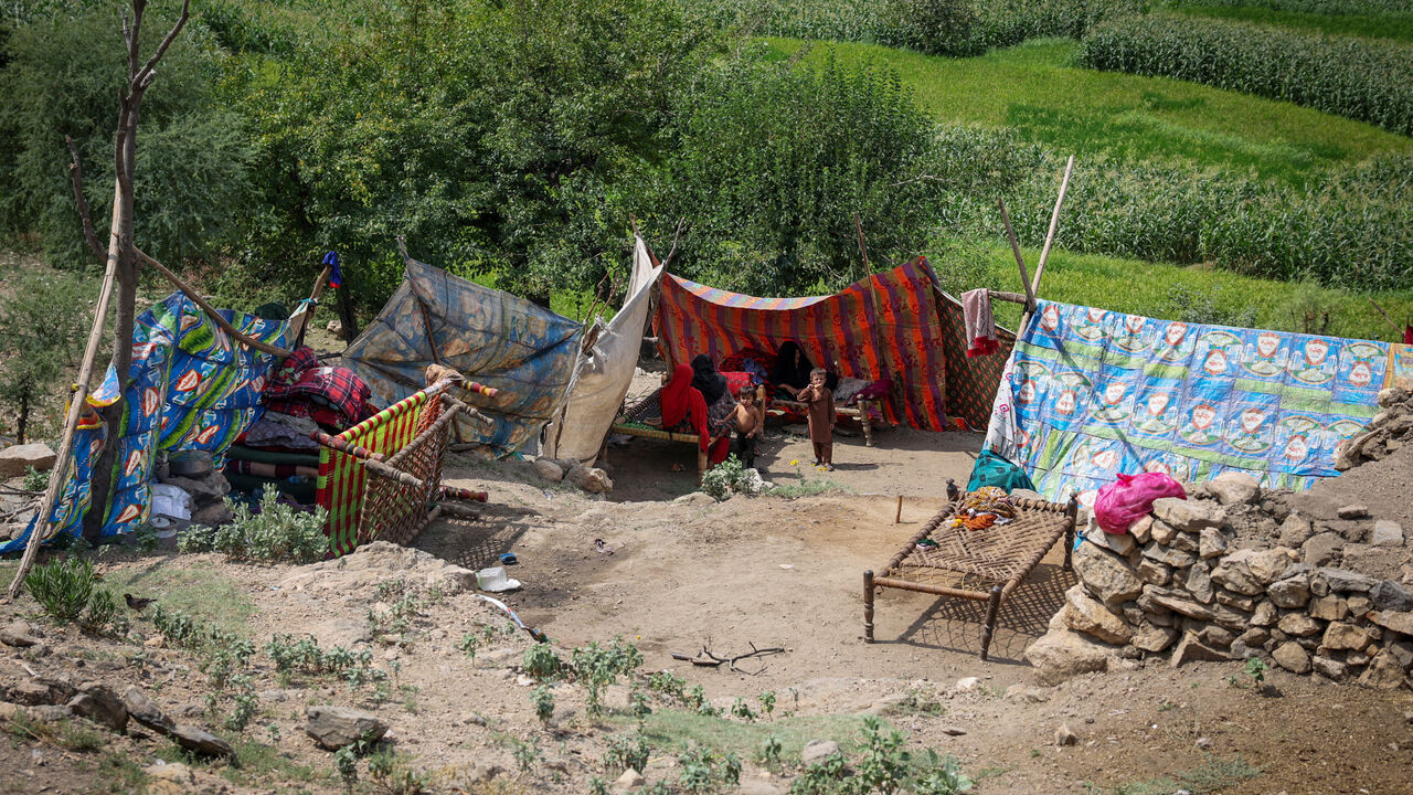 An Afghan family sits inside a makeshift shelter following a deadly magnitude-6 earthquake that struck Afghanistan on Sunday, at Lulam village, in Nurgal district, Kunar province, Afghanistan, September 3. REUTERS/Sayed Hassib