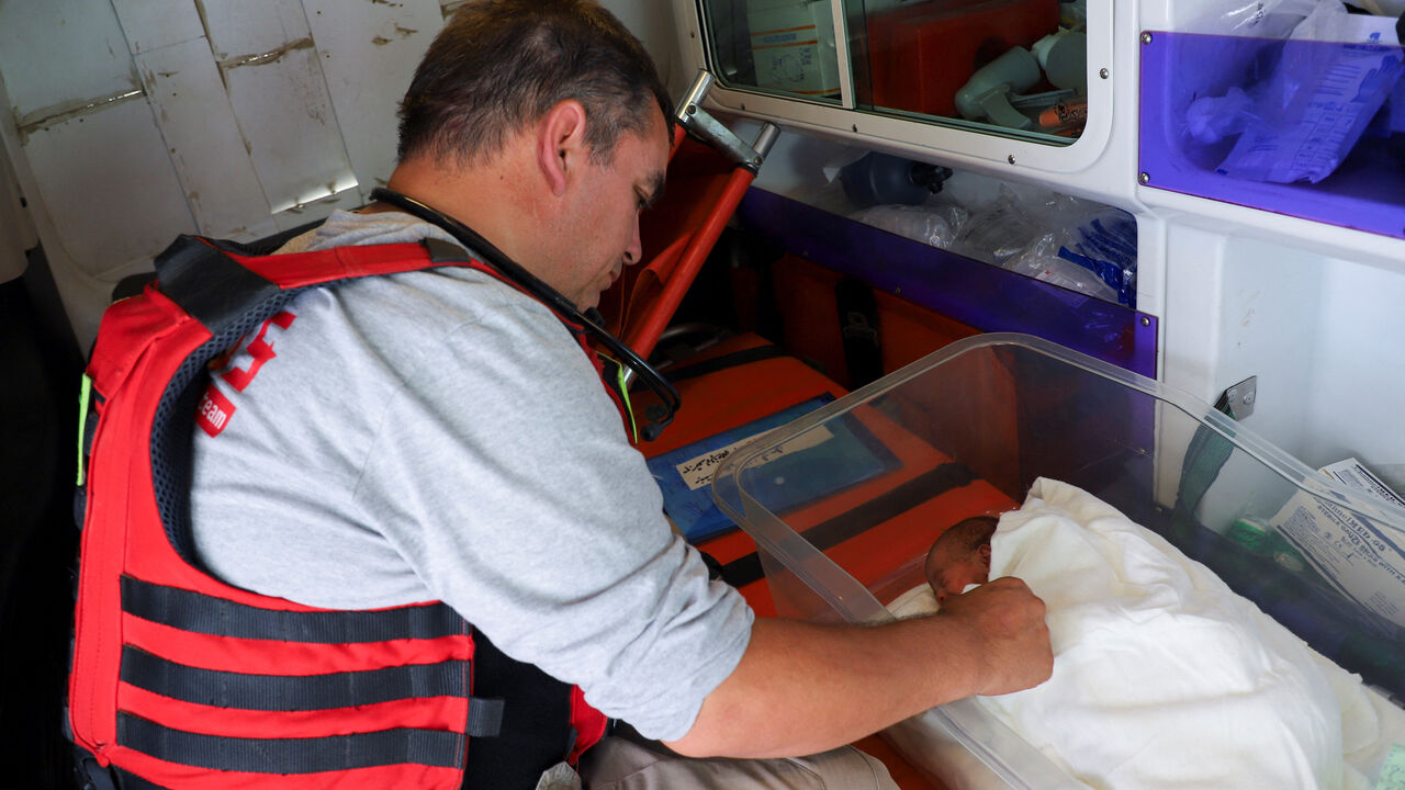 A member of the staff of Cadus organization evacuates a premature baby from Al Helo International Hospital to be transported to a hospital in southern Gaza for further medical care, amid an Israeli military operation, in Gaza City October 3, 2025. REUTERS/Ebrahim Hajjaj