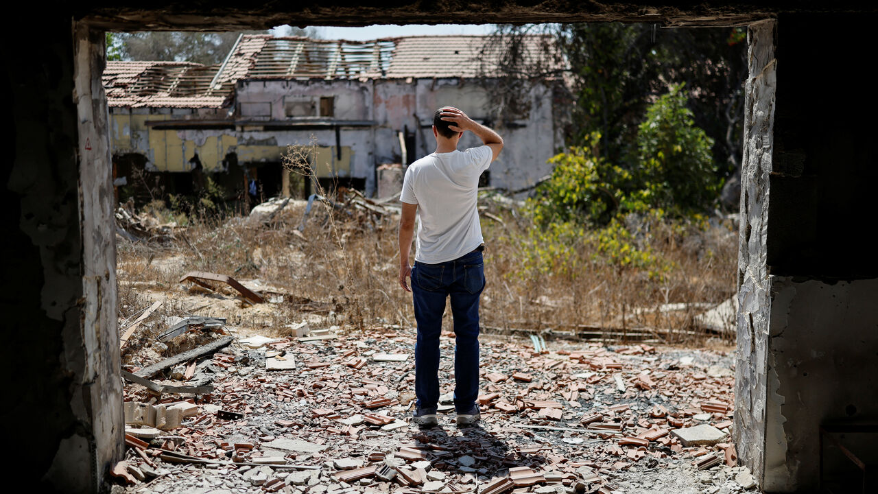 Tal Shoham, a former hostage who was kidnapped by Hamas on October 7, 2023, with his wife and two children as well as three other members of his family, and held in Gaza for 505 days, stands by the entrance to the home of his in-laws' in Kibbutz Beeri, southern Israel, September 15, 2025. REUTERS/Amir Cohen