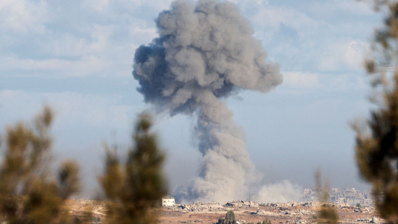 Smoke rises from an explosion in Gaza, as people attend a memorial to commemorate the two-year anniversary of the deadly October 7, 2023 attack on Israel by Hamas from Gaza, in Kibbutz Kfar Aza, as seen from southern Israel, October 7, 2025. REUTERS/Ronen Zvulun