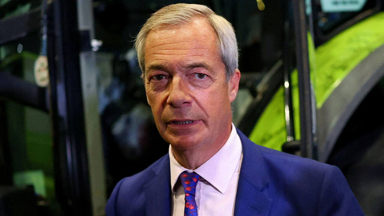 FILE PHOTO: Britain's Reform UK party leader Nigel Farage stands next to a tractor during the Reform UK party conference, in Birmingham, Britain, September 6, 2025. REUTERS/Isabel Infantes/File Photo