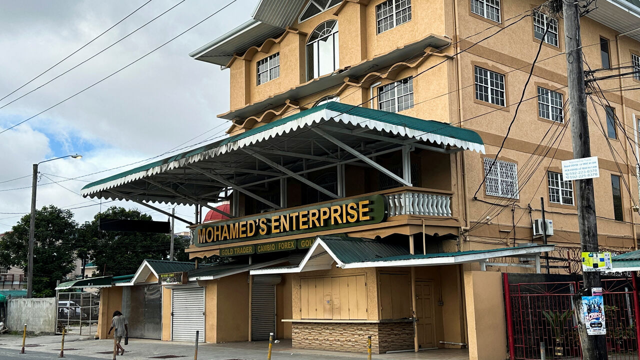 FILE PHOTO: A man passes by Mohamed's Enterprise office in Georgetown, Guyana, June 29, 2023. REUTERS/Sabrina Valle/File Photo