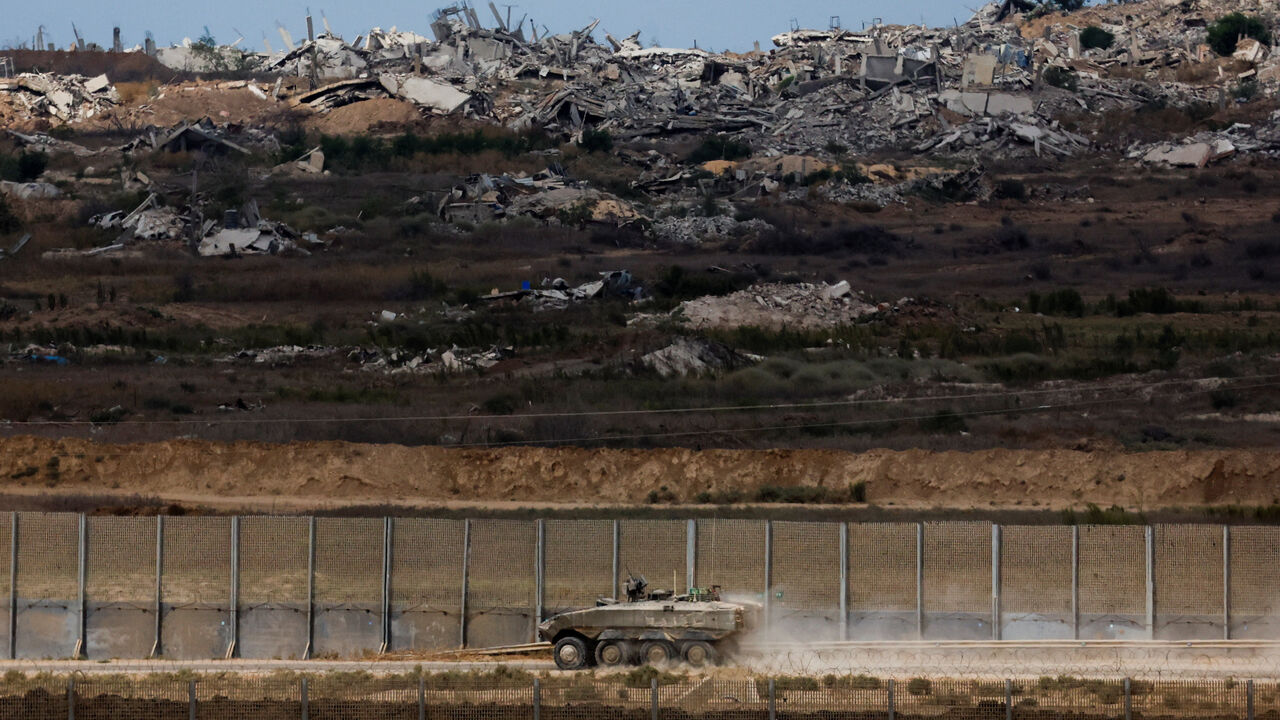 An Israeli armoured personnel carrier (APC) manoeuvres, after U.S. President Donald Trump announced that Israel and Hamas agreed on the first phase of a Gaza ceasefire, on the Israeli side of the border with Gaza, October 9, 2025. REUTERS/Ammar Awad