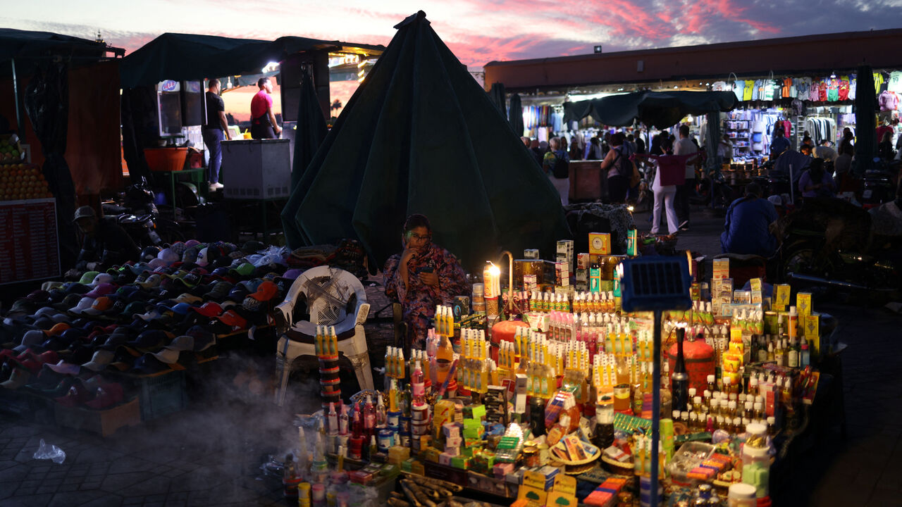 A street vendor sits next to her merchandise in Jemaa el-Fnaa square, in Marrakesh, Morocco, October 21, 2024. REUTERS/Stelios Misinas