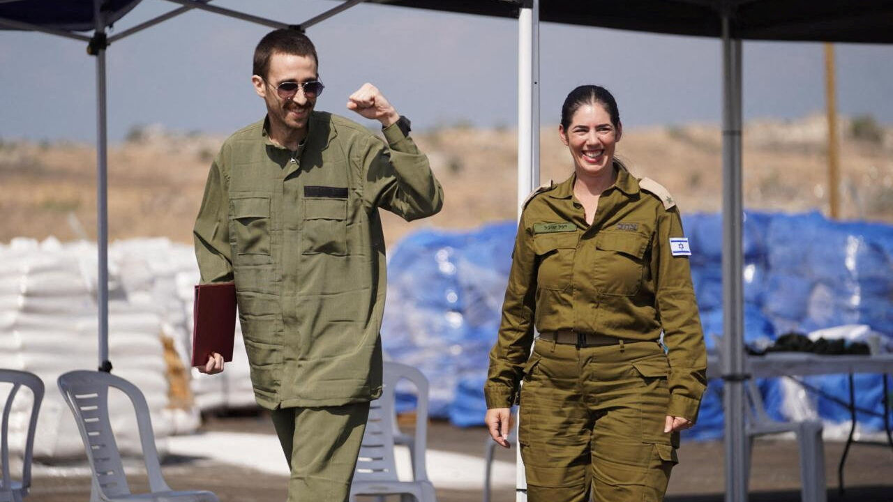 Released Israeli hostage, Avinatan Or, held in Gaza since the deadly October 7, 2023 attack by Hamas, reacts as he walks with a representative of the Israeli army after being released, as part of a prisoner-hostage swap and a ceasefire deal between Israel and Hamas, in Reim, Israel October 13, 2025. Israel Defense Forces/Handout via REUTERS