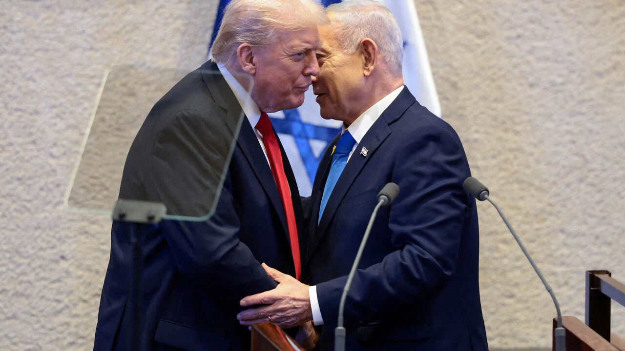 U.S. President Donald Trump and Israeli Prime Minister Benjamin Netanyahu stand at the Knesset on the day Trump addresses it, amid a U.S.-brokered prisoner-hostage swap and ceasefire deal between Israel and Hamas, in Jerusalem, October 13, 2025. REUTERS/Evelyn Hockstein/Pool