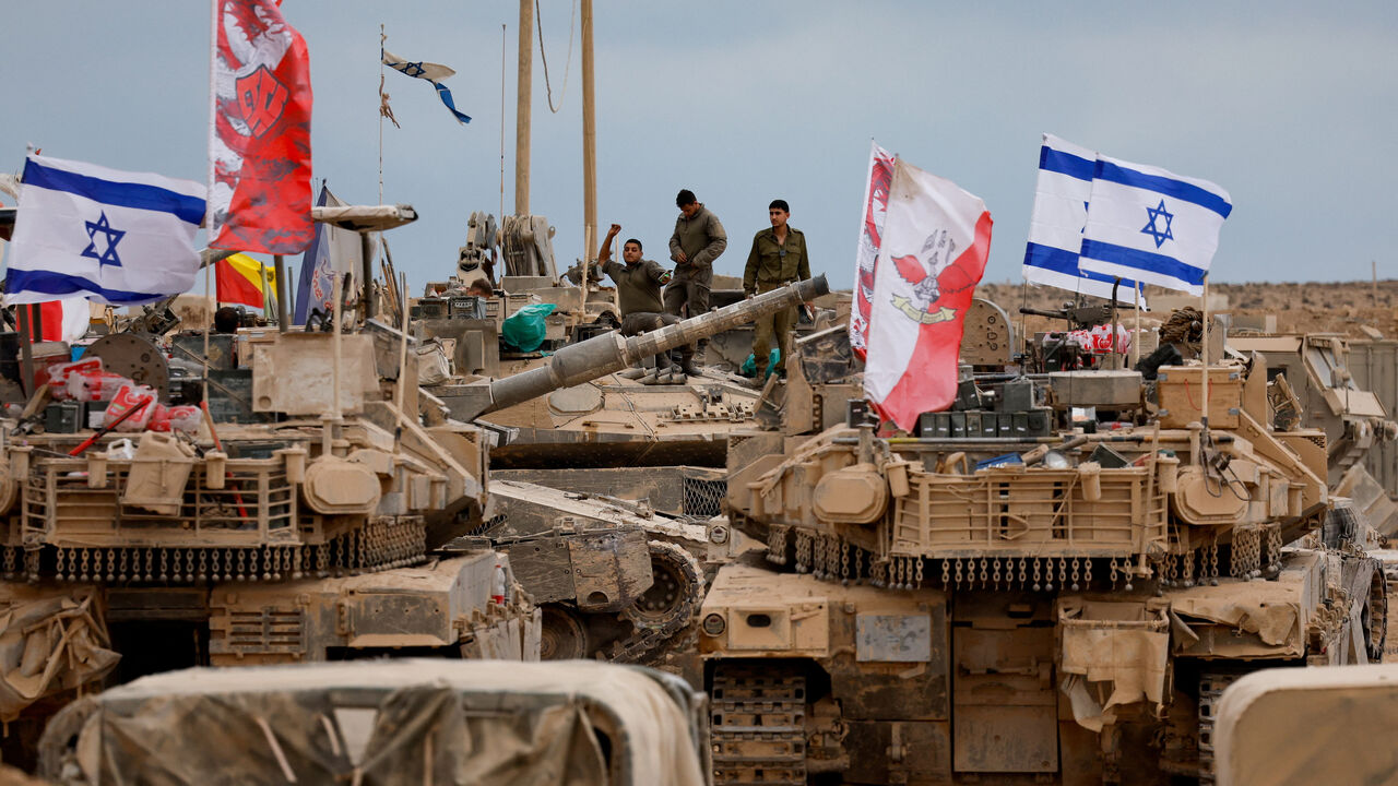 Military vehicles surround Israeli soldiers near the Israel-Gaza border, amid a ceasefire between Israel and Hamas in Gaza, in southern Israel, October 12, 2025. REUTERS/Ammar Awad