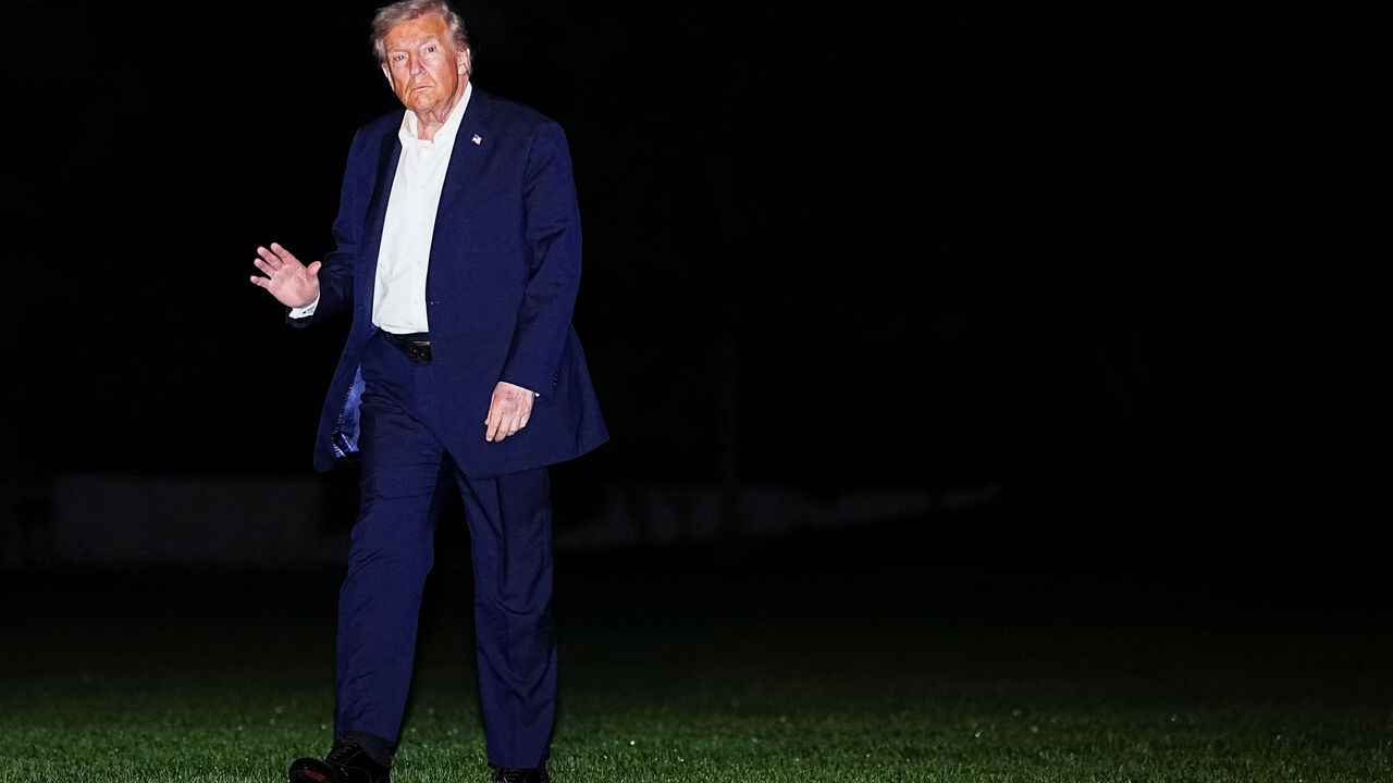 U.S. President Donald Trump waves while walking on the South Lawn as he arrives back at the White House, after participating in a world leaders' summit in Egypt on ending the Gaza war, amid a ceasefire between Israel and Hamas in Gaza, in Washington, D.C., U.S., October 14, 2025. REUTERS/Aaron Schwartz