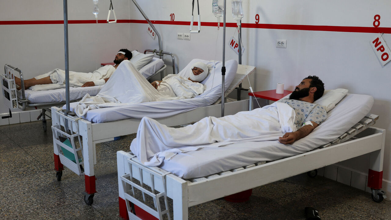 People injured during airstrikes amid the conflict between Afghanistan and Pakistan, lie on hospital beds following a temporary ceasefire, in Kabul, Afghanistan October 16, 2025. REUTERS/Sayed Hassib