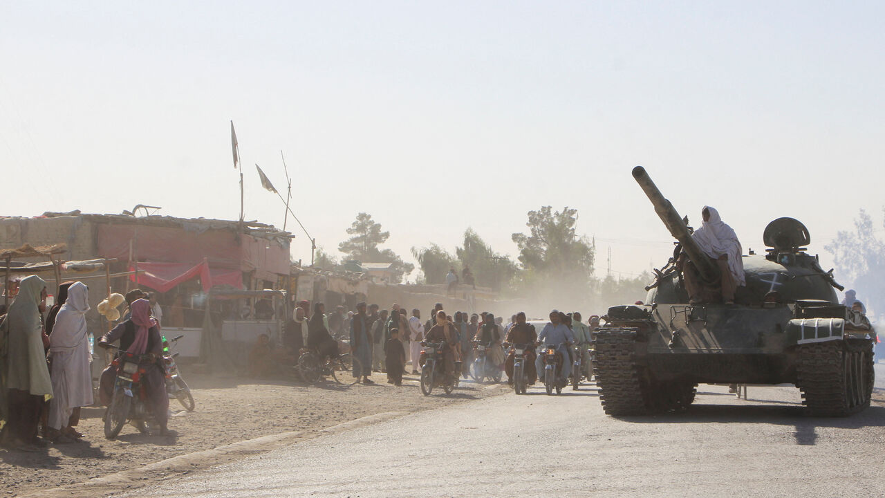 An Afghan Taliban fighter sits on a tank near the Afghanistan-Pakistan border in Spin Boldak, Kandahar Province, following exchanges of fire between Pakistani and Afghan forces in Afghanistan, October 15, 2025. REUTERS/Stringer