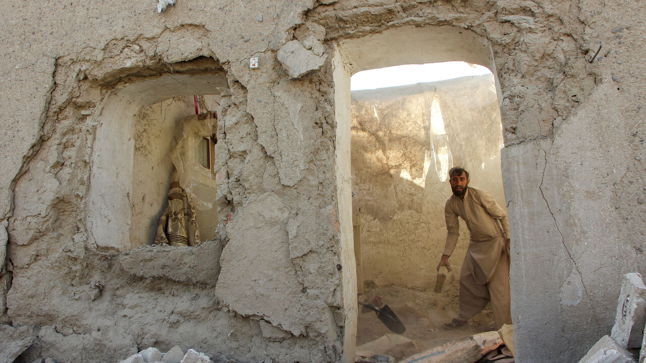 A man clears debris from his house damaged during an airstrike, following a temporary ceasefire, amid the conflict between Afghanistan and Pakistan, in Spin Boldak district of Kandahar Province, Afghanistan. REUTERS/Stringer