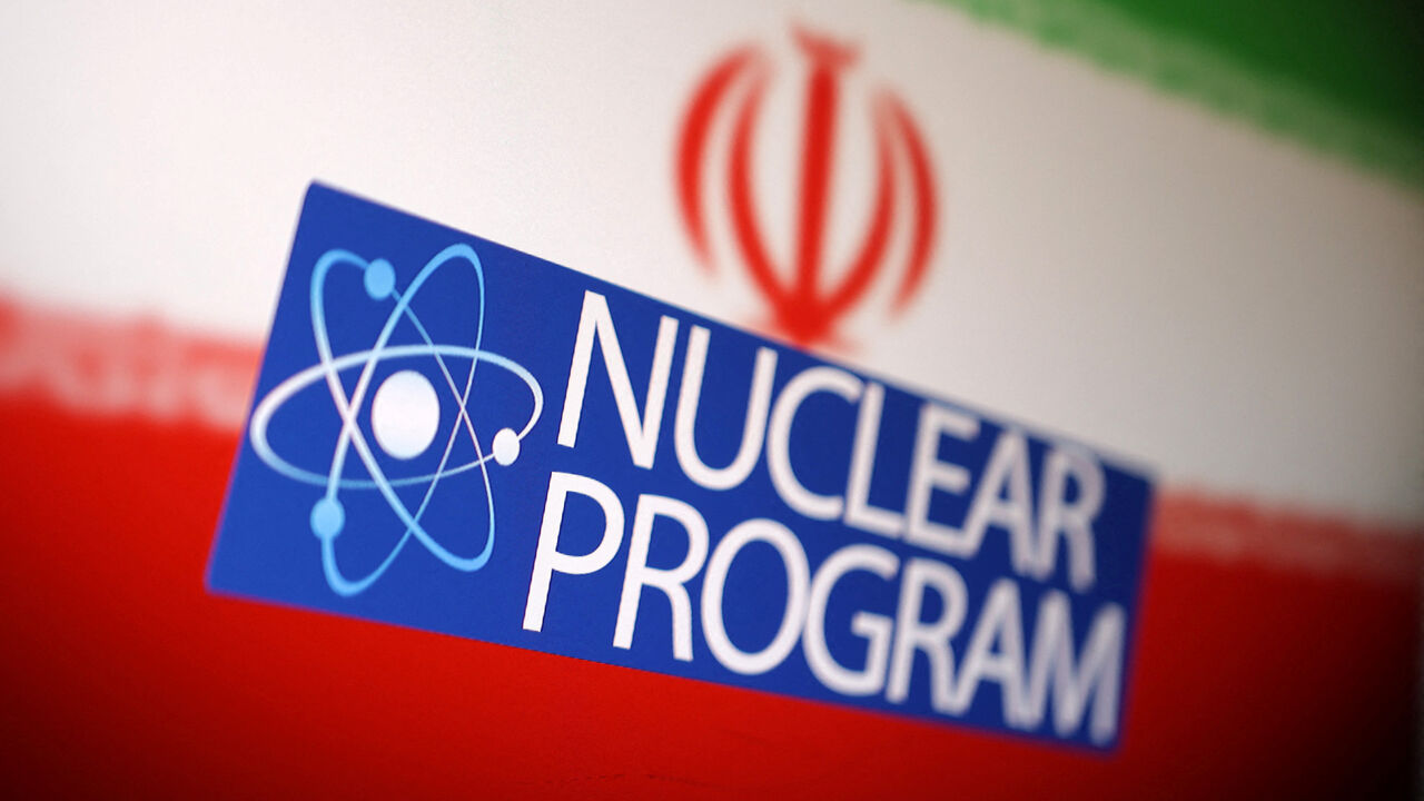 Iranian flag, atom symbol and words "Nuclear program" are seen in this illustration taken June 16, 2025. REUTERS/Dado Ruvic/Illustration