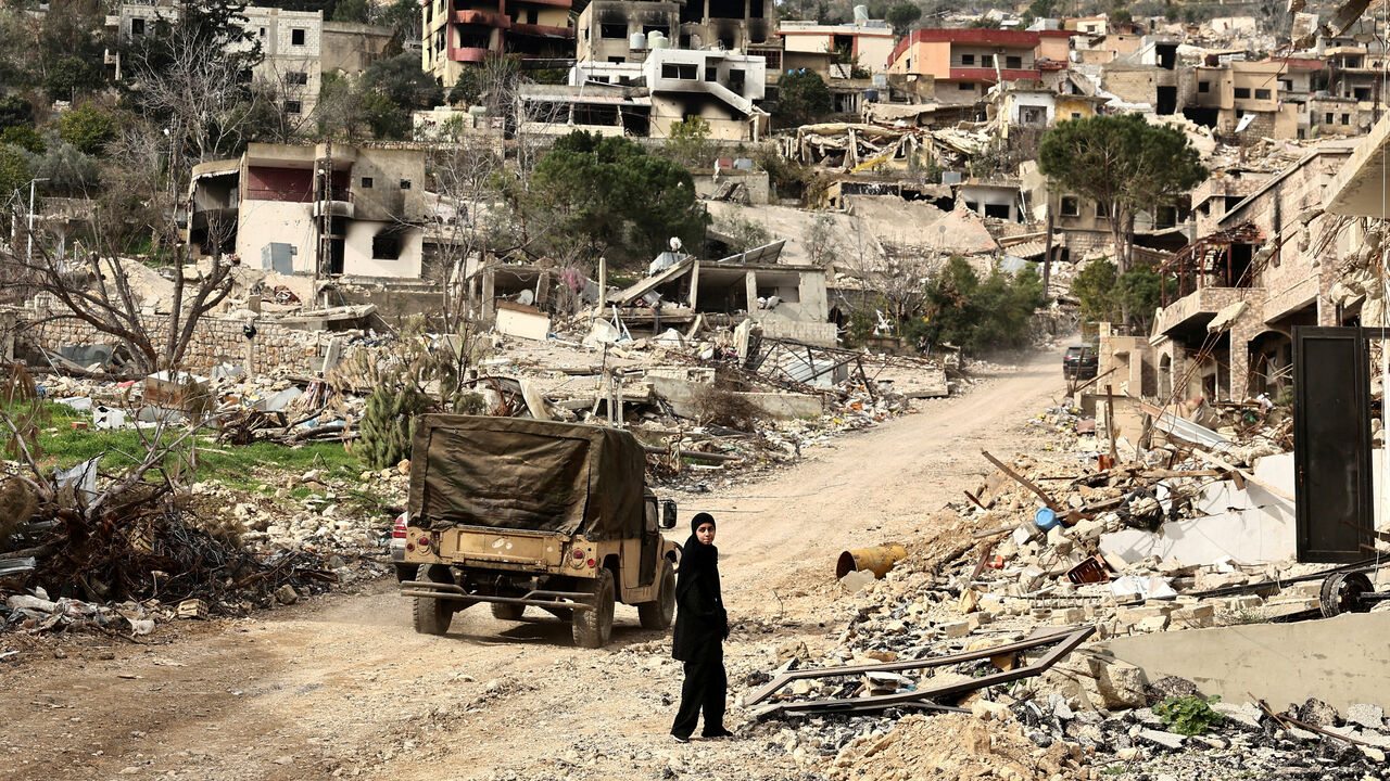 FILE PHOTO: A returning resident walks near a damaged site amid destroyed buildings, as Israeli troops withdrew from most of south Lebanon, in the southern Lebanese village of Kfar Kila, Lebanon, February 19, 2025. REUTERS/Emilie Madi /File Photo