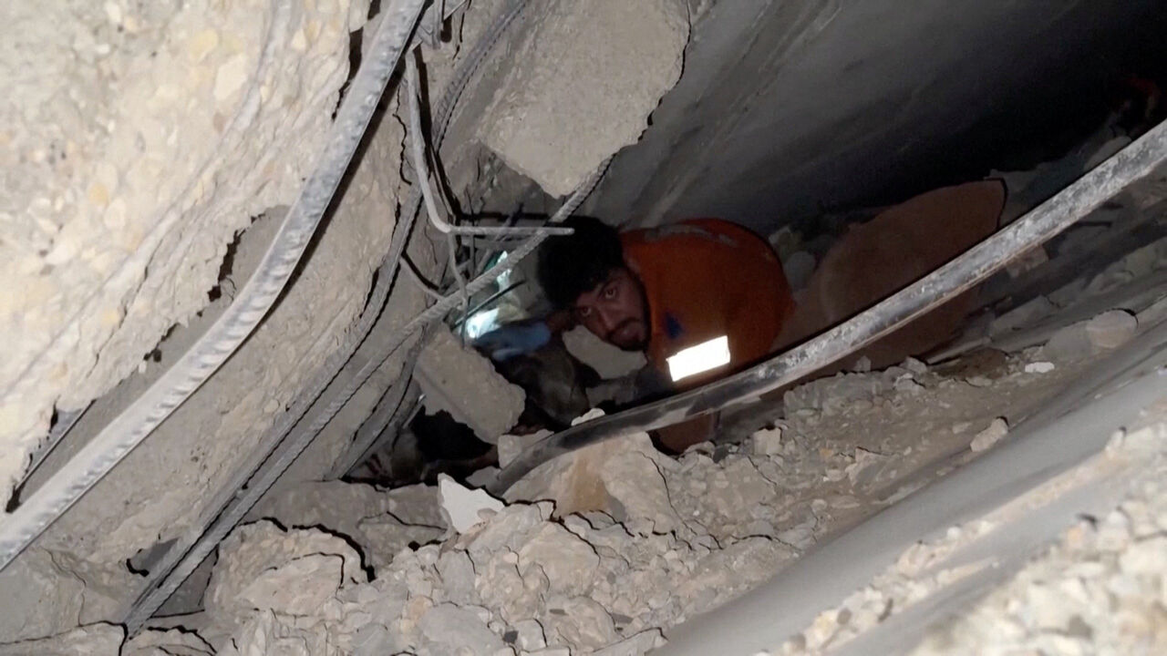 A rescuer works to free people trapped in rubble after an Israeli strike in Gaza City, October 28, 2025, in this still image taken from video.   Obtained by Reuters/Handout via REUTERS    THIS IMAGE HAS BEEN SUPPLIED BY A THIRD PARTY. NO RESALES. NO ARCHIVES