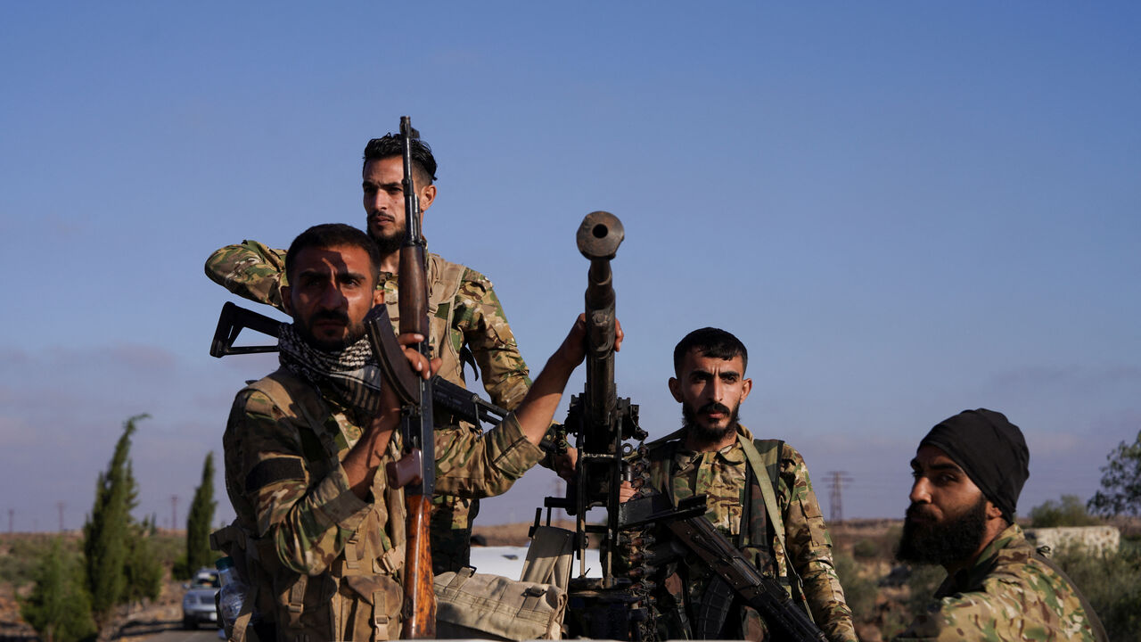 Members of Syrian security forces ride on a back of a truck in Druze city in Sweida, Syria July 15, 2025. REUTERS/Karam al-Masri/File Photo