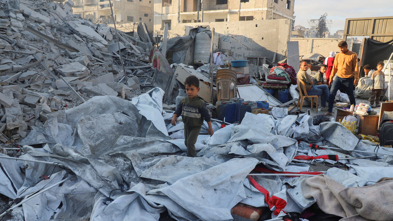 A Palestinian kid walks at the site of an overnight Israeli strike on a house, in Gaza City, October 29, 2025. REUTERS/Ebrahim Hajjaj