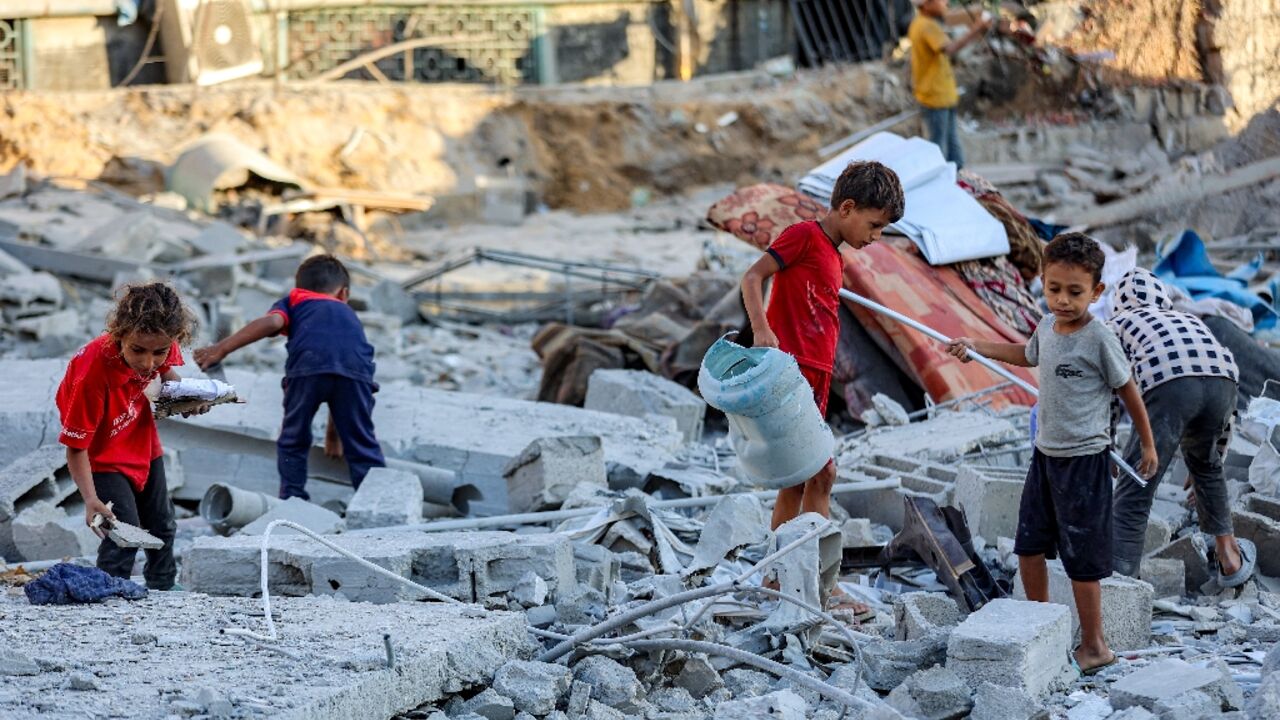 Children search through rubble in Gaza City 
