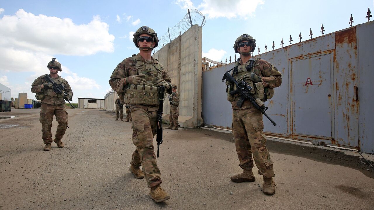US army soldiers, part of the Combined Joint Task Force Operation Inherent Resolve (CJTF-OIR) the US-led coalition against the Islamic State (IS) group, walk around at the K1 Air Base northwest of Kirkuk in northern Iraq before a planned US pullout on March 29, 2020.