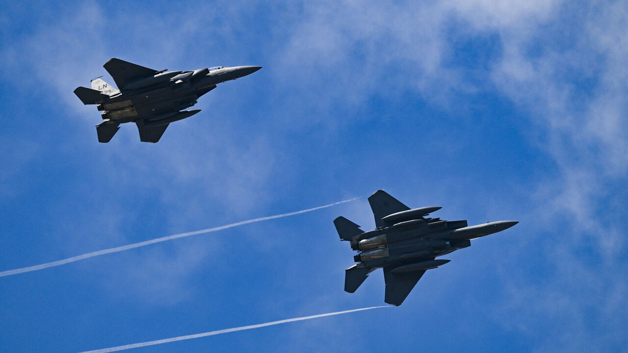 Two F-15 Strike Eagle's take part in an air display on the opening day of the Farnborough International Airshow 2024, south west of London, on July 22, 2024. 