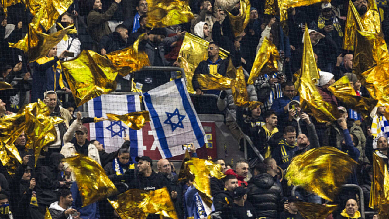 OPSHOT - Maccabi supporters wave yellow flags next to Israeli flags during the UEFA Europa League, League phase - Matchday 4, football match between Ajax Amsterdam and Maccabi Tel Aviv at the Johan-Cruijff stadium, in Amsterdam on November 7, 2024. (Photo by Robin van Lonkhuijsen / ANP / AFP) / Netherlands OUT (Photo by ROBIN VAN LONKHUIJSEN/ANP/AFP via Getty Images)