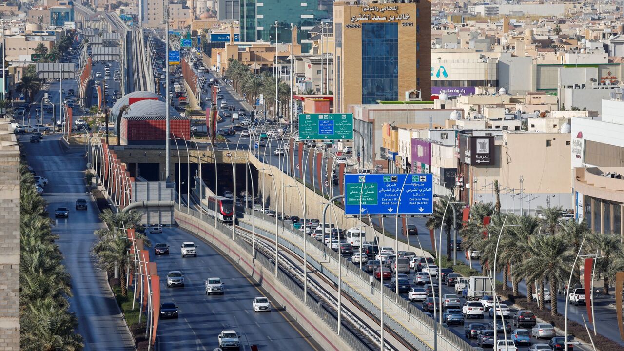 A Riyadh Metro train makes its way along a track in the middle of a road in Riyadh on December 3, 2024. 