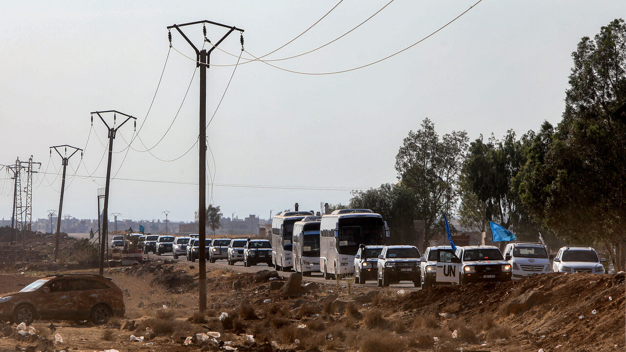 A United Nations convoy evacuating families from Sweida moves through the buffer zone in Busra al-Harir in Syria's southern Daraa province on July 22, 2025. 