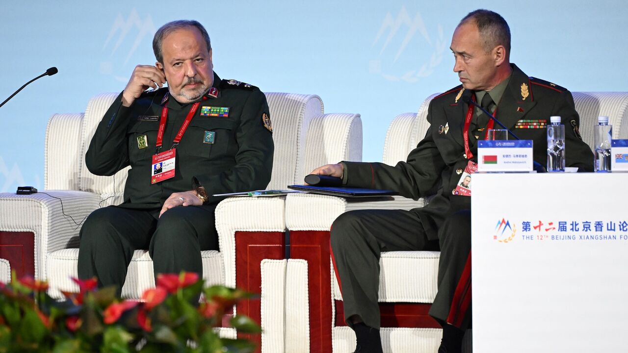 Iran's Deputy Defense Minister Majid Ebnoreza (L) sits next to Andrei Matsiyevich.