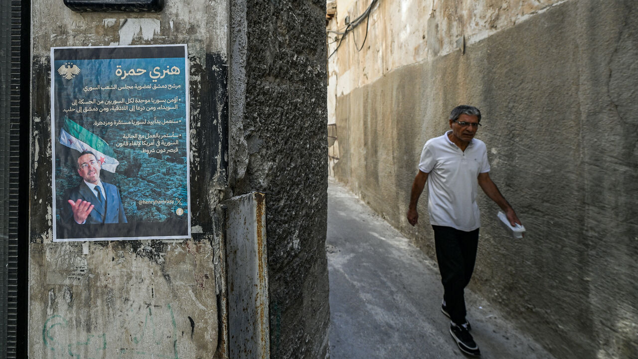 An election poster of Henry Hamra, a Syrian-American parliamentary candidate who is the son of the country's last rabbi and who if elected will be the first Jewish representative in the Syrian parliament since the late 1940s, is displayed on the entrance of the closed Jewish Maimonides School of Damascus, in the Jewish quarter of the old city of Damascus on Oct. 3, 2025, ahead of the upcoming vote on Oct. 5. 