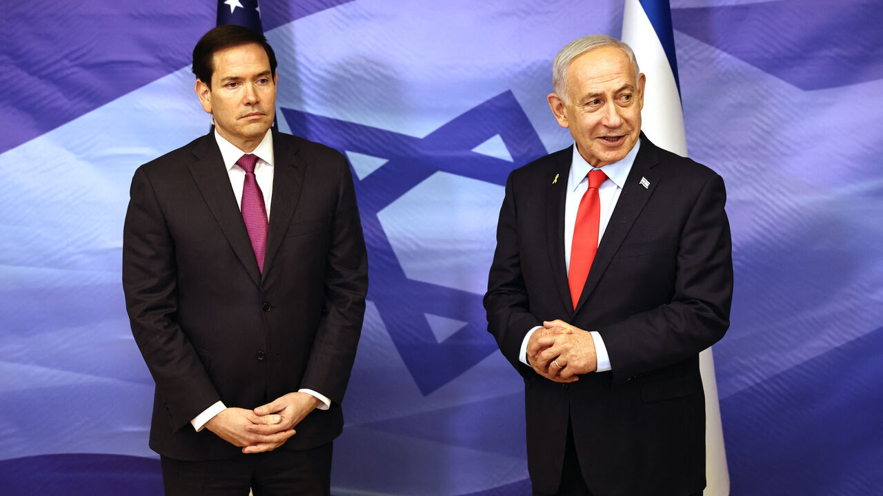 US Secretary of State Marco Rubio (L) looks on as Israeli Prime Minister Benjamin Netanyahu speaks following their meeting at the Prime Minister's office in Jerusalem on Oct. 23, 2025.