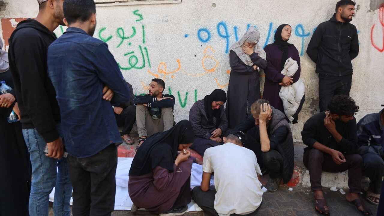 Palestinians mourn over the body of a relative who was killed in overnight Israeli strikes on Gaza
