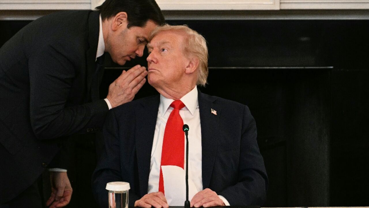 US Secretary of State Marco Rubio whispers in the ear of President Donald Trump during a roundtable about Antifa in the State Dining Room of the White House 