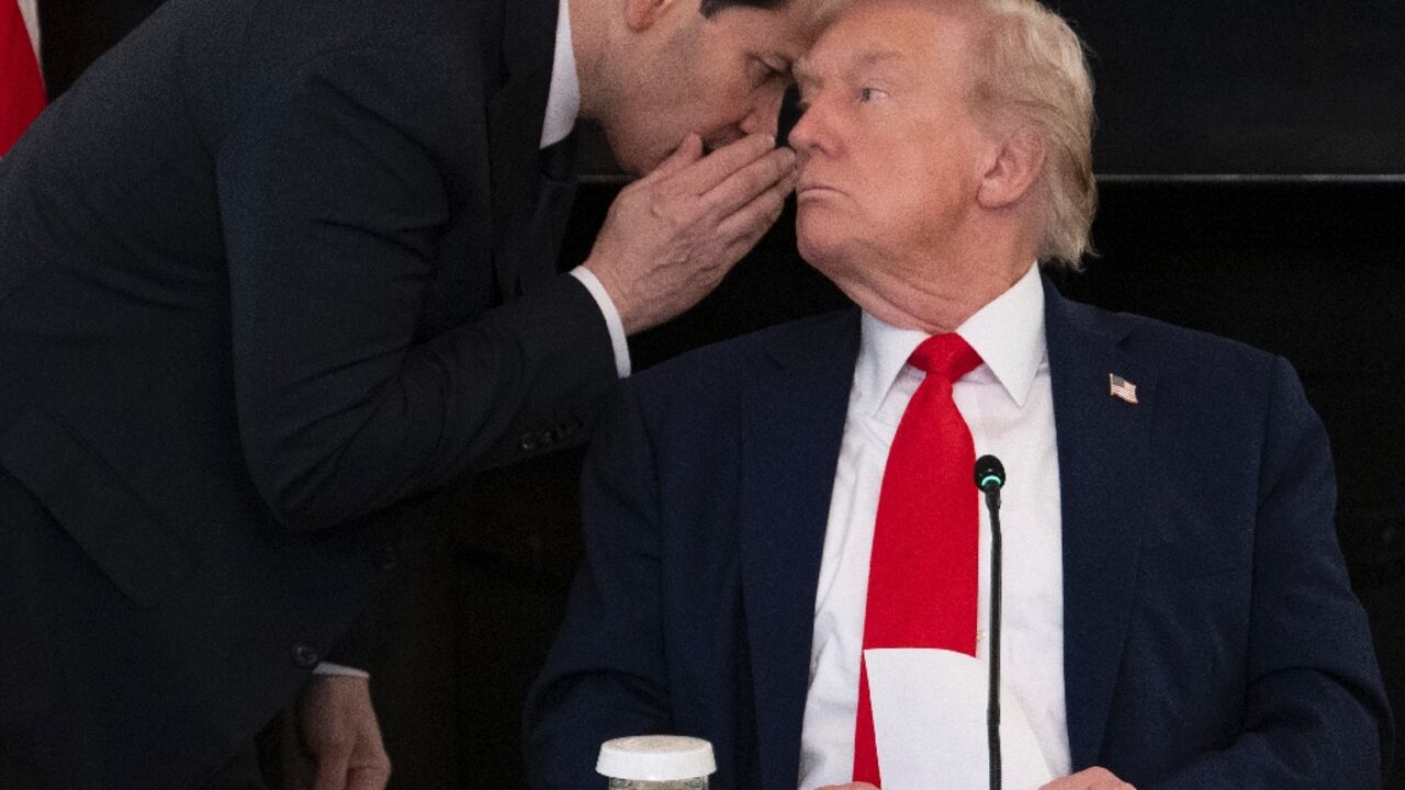 US Secretary of State Marco Rubio whispers to President Donald Trump at the White House after handing him a note saying the Middle East peace deal is 'very close'