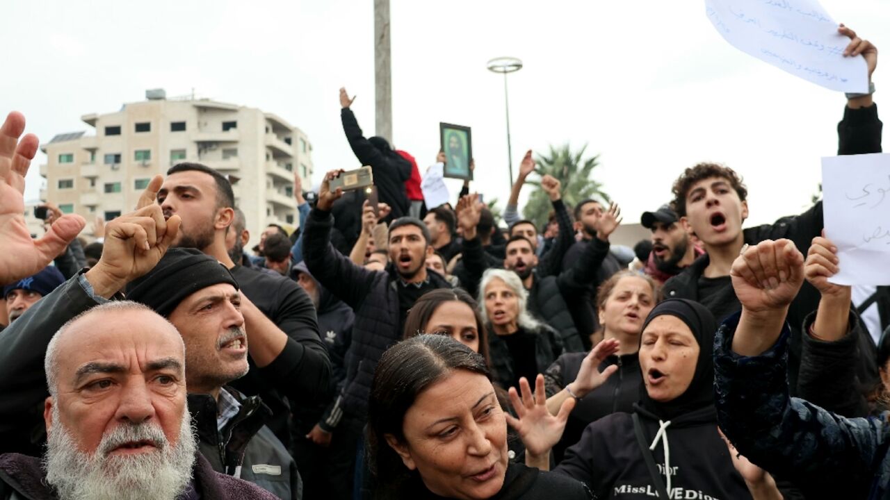 Demonstrators in Latakia's Al-Azhari Square protest against attacks targeting Syria's minority Alawite community